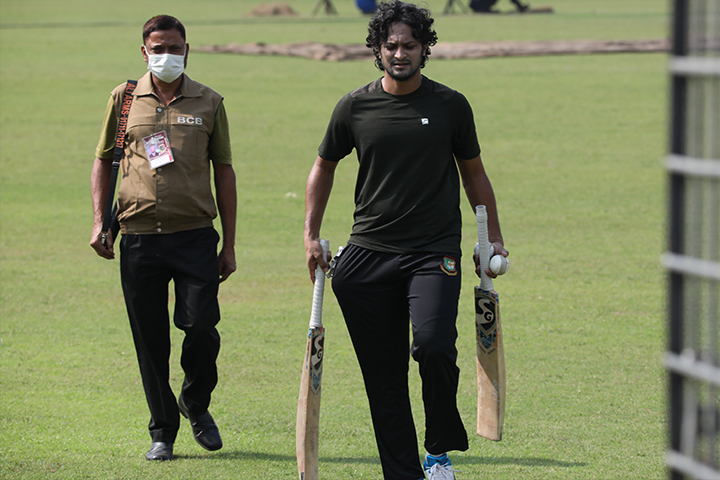 Shakib on the field with armed security personnel